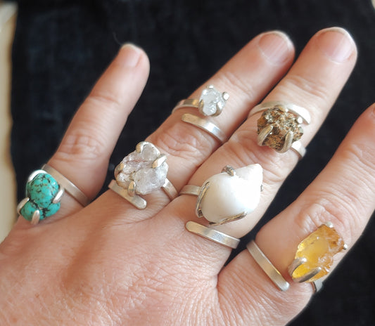 Adjustable sterling silver ring, prong set stone.